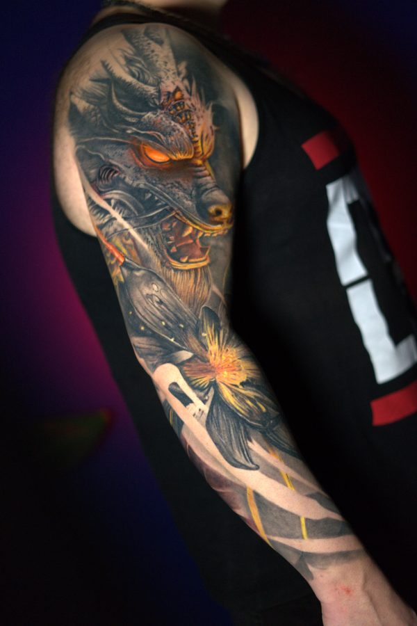 realistic black and grey dragon and flower tattoo with yellow color and glowing eyes on arm, sleeve by Mihaly Forgony